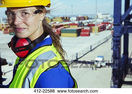 Worker smiling near cargo containers View Large Photo Image Stock Photo - Worker smiling near cargo containers. Fotosearch