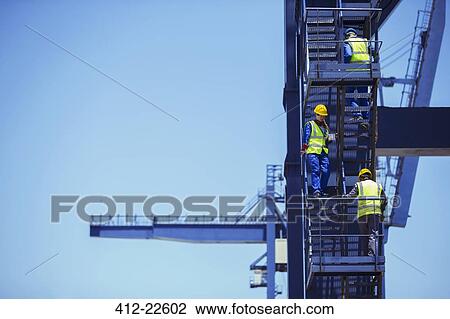 Workers climbing cargo crane View Large Photo Image Stock Image - Workers climbing cargo crane. Fotosearch