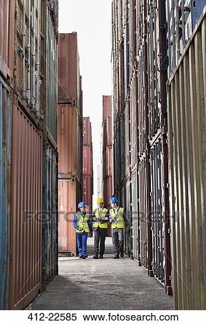 Workers talking between cargo containers View Large Photo Image Stock Photography - Workers talking between cargo containers. Fotosearch