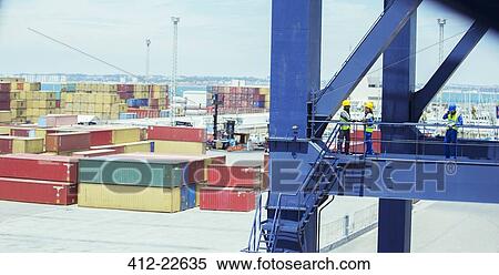 Workers talking on cargo crane View Large Photo Image Stock Photography - Workers talking on cargo crane. Fotosearch