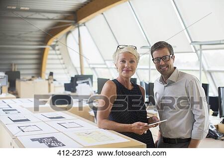 Business people smiling in office View Large Photo Image Stock Image - Business people smiling in office. Fotosearch