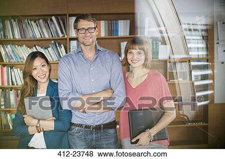 Stock Photo - Business people smiling in office. Fotosearch