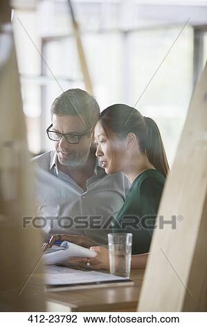 Business people talking at office desk View Large Photo Image Stock Image - Business people talking at office desk. Fotosearch