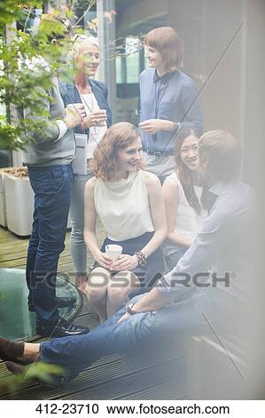 Business people talking in courtyard View Large Photo Image Stock Image - Business people talking in courtyard. Fotosearch