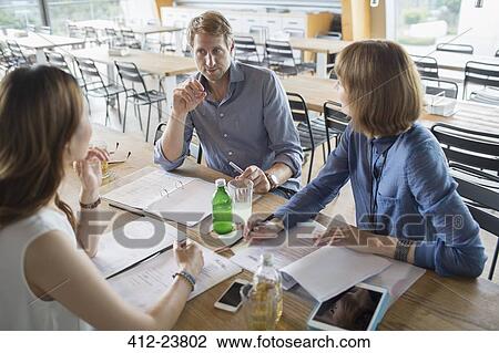 Business people talking in meeting in cafeteria View Large Photo Image Stock Image - Business people talking in meeting in cafeteria. Fotosearch