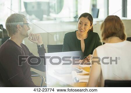 Business people talking in office meeting View Large Photo Image Picture - Business people talking in office meeting. Fotosearch