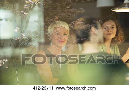 Stock Image - Business people talking in office meeting. Fotosearch