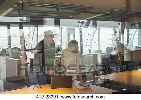 Stock Image - Business people talking in office. Fotosearch