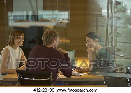 Stock Image - Business people talking in office meeting. Fotosearch