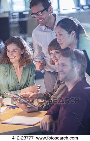 Stock Photo - Business people talking in office meeting. Fotosearch