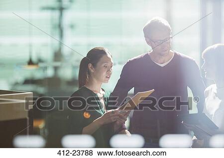 Stock Photo - Business people talking in office. Fotosearch