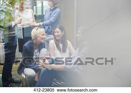 Business people talking in office courtyard View Large Photo Image Stock Photography - Business people talking in office courtyard. Fotosearch