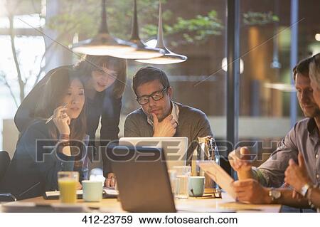 Business people using laptop in office meeting View Large Photo Image Stock Photo - Business people using laptop in office meeting. Fotosearch