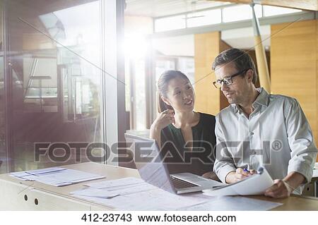 Business people working on laptop in office View Large Photo Image Stock Image - Business people working on laptop in office. Fotosearch