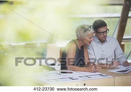 Business people working together in office View Large Photo Image Stock Image - Business people working together in office. Fotosearch