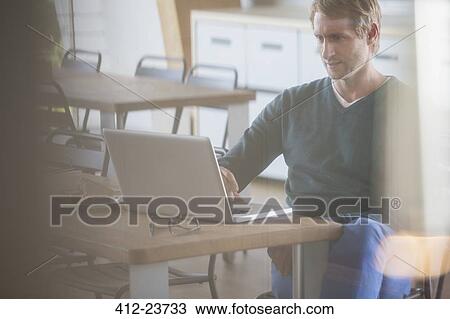 Businessman working on laptop in office View Large Photo Image Stock Image - Businessman working on laptop in office. Fotosearch