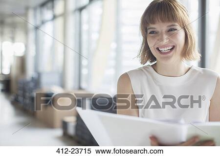 Businesswoman laughing in office View Large Photo Image Stock Photography - Businesswoman laughing in office. Fotosearch