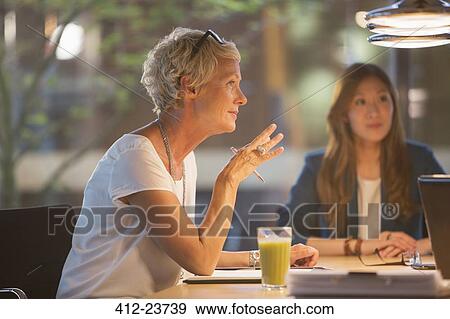 Businesswoman talking in office meeting View Large Photo Image Stock Photo - Businesswoman talking in office meeting. Fotosearch