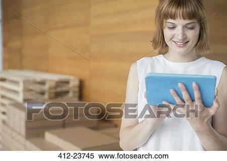 Businesswoman using digital tablet in office View Large Photo Image Stock Photography - Businesswoman using digital tablet in office. Fotosearch
