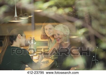 Businesswomen shaking hands in office meeting View Large Photo Image Stock Photography - Businesswomen shaking hands in office meeting. Fotosearch