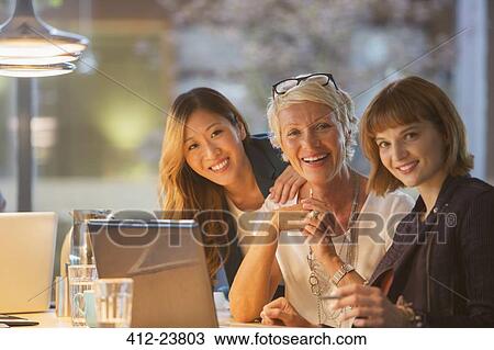 Businesswomen smiling in office View Large Photo Image Stock Image - Businesswomen smiling in office. Fotosearch