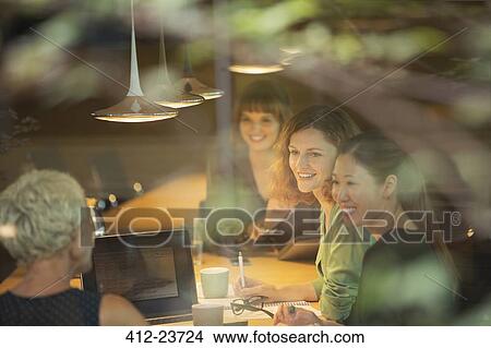 Businesswomen talking in office meeting View Large Photo Image Picture - Businesswomen talking in office meeting. Fotosearch