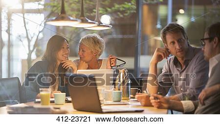 Businesswomen talking in office meeting View Large Photo Image Stock Image - Businesswomen talking in office meeting. Fotosearch