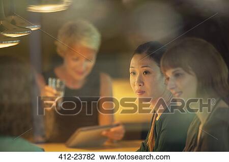 Businesswomen talking in office meeting View Large Photo Image Stock Image - Businesswomen talking in office meeting. Fotosearch