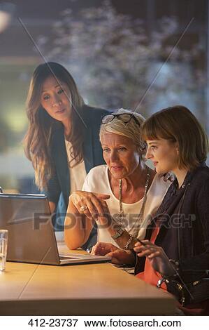 Businesswomen working together in office meeting View Large Photo Image Stock Photo - Businesswomen working together in office meeting. Fotosearch