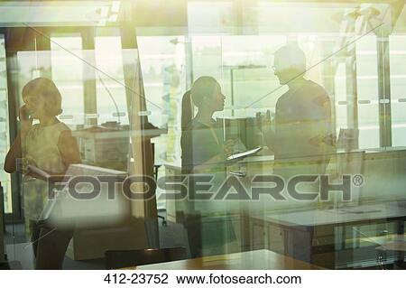 Stock Image - Silhouette of business people talking in office. Fotosearch