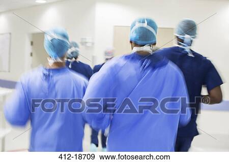 Blurred motion of surgeons walking towards hospital View Large Photo Image Stock Photo - Blurred motion of surgeons walking towards hospital. Fotosearch