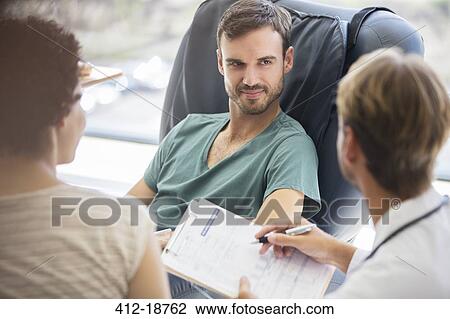 Doctor questioning patient and writing on clipboard View Large Photo Image Stock Image - Doctor questioning patient and writing on clipboard. Fotosearch