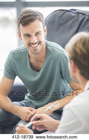 Doctor talking to patient in hospital View Large Photo Image Stock Photo - Doctor talking to patient in hospital. Fotosearch