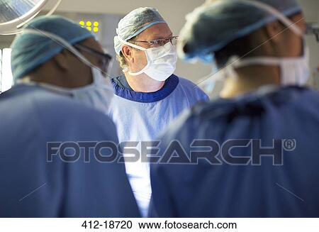 Doctors performing surgery in operating theater View Large Photo Image Stock Image - Doctors performing surgery in operating theater. Fotosearch