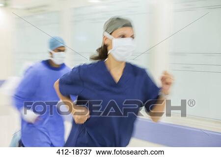 Stock Photo - Doctors rushing through hospital corridor. Fotosearch