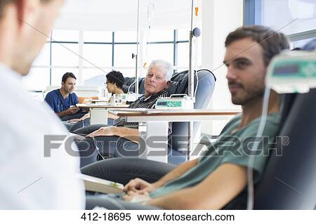 Doctors talking to patients receiving medical treatment in hospital ward View Large Photo Image Stock Photography - Doctors talking to patients receiving medical treatment in hospital ward. Fotosearch