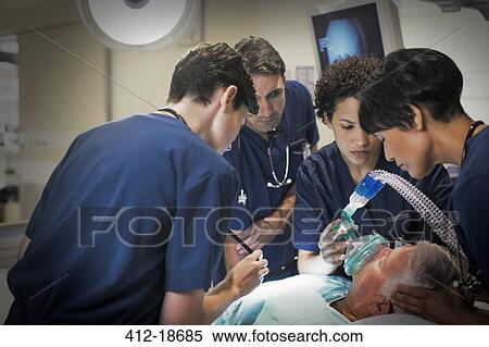 Female doctor wearing mask while anesthetizing elderly patient in hospital ward View Large Photo Image Stock Photography - Female doctor wearing mask while anesthetizing elderly patient in hospital ward. Fotosearch