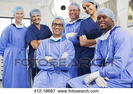 Stock Photo - Group portrait of surgeons posing in operating theater. Fotosearch