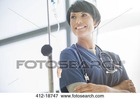 Portrait of female doctor in front of hospital window View Large Photo Image Stock Photo - Portrait of female doctor in front of hospital window. Fotosearch