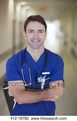 Stock Image - Portrait of male doctor in hospital corridor. Fotosearch