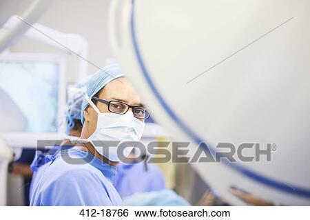 Portrait of masked surgeon in operating theater View Large Photo Image Stock Photograph - Portrait of masked surgeon in operating theater. Fotosearch