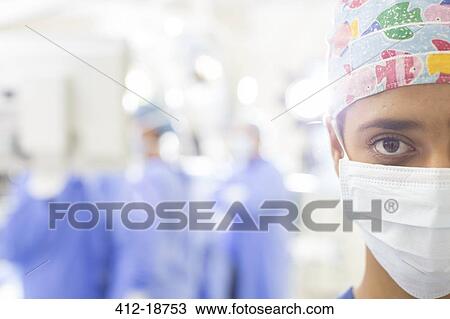 Portrait of masked surgeon with blurred hospital setting in background View Large Photo Image Stock Image - Portrait of masked surgeon with blurred hospital setting in background. Fotosearch