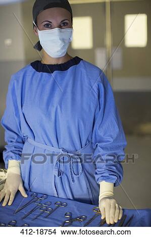 Portrait of masked surgeon with set of surgical instruments in operating theater View Large Photo Image Picture - Portrait of masked surgeon with set of surgical instruments in operating theater. Fotosearch