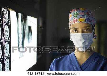 Portrait of young female doctor standing near screen with MRI image View Large Photo Image Stock Image - Portrait of young female doctor standing near screen with MRI image. Fotosearch