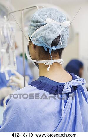Rear view of female surgeon standing in operating theater View Large Photo Image Stock Photo - Rear view of female surgeon standing in operating theater. Fotosearch