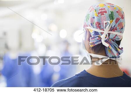 Rear view of young nurse standing in operating theater View Large Photo Image Stock Photography - Rear view of young nurse standing in operating theater. Fotosearch