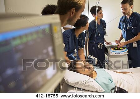 Team of doctors attending patient in hospital View Large Photo Image Stock Photography - Team of doctors attending patient in hospital. Fotosearch