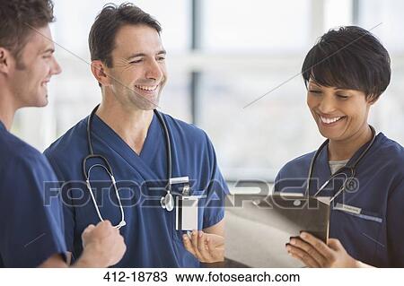 Team of doctors laughing in hospital View Large Photo Image Stock Image - Team of doctors laughing in hospital. Fotosearch