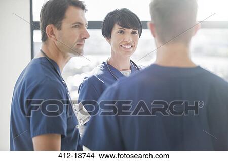 Team of doctors talking in hospital View Large Photo Image Picture - Team of doctors talking in hospital. Fotosearch