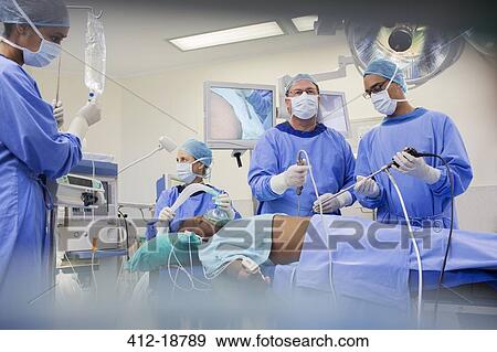 Team of surgeons operating on patient in hospital View Large Photo Image Stock Photo - Team of surgeons operating on patient in hospital. Fotosearch